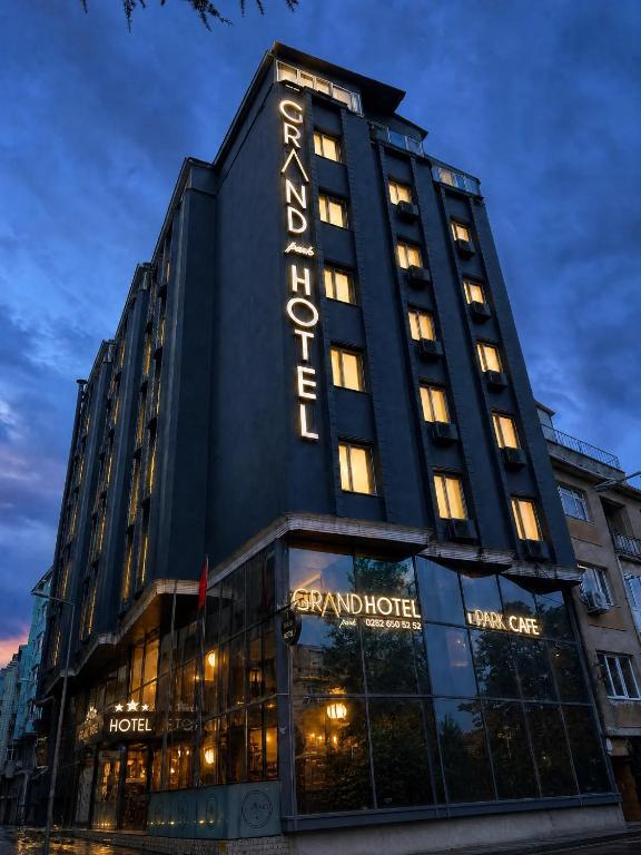 a building with a sign on the side of it at Grand Park Hotel Corlu City Center Bed and Breakfast in Çorlu