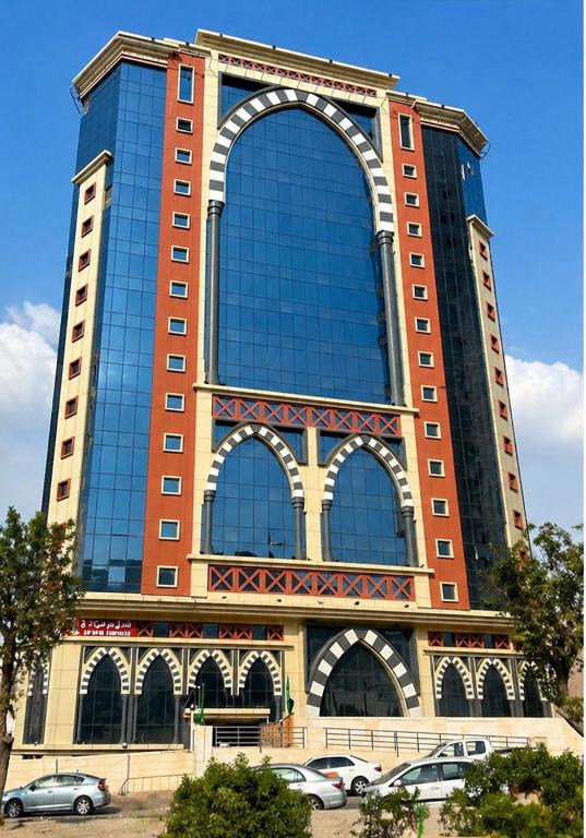 a large building with cars parked in front of it at فندق نمبر وان 3 in Al Masfalah