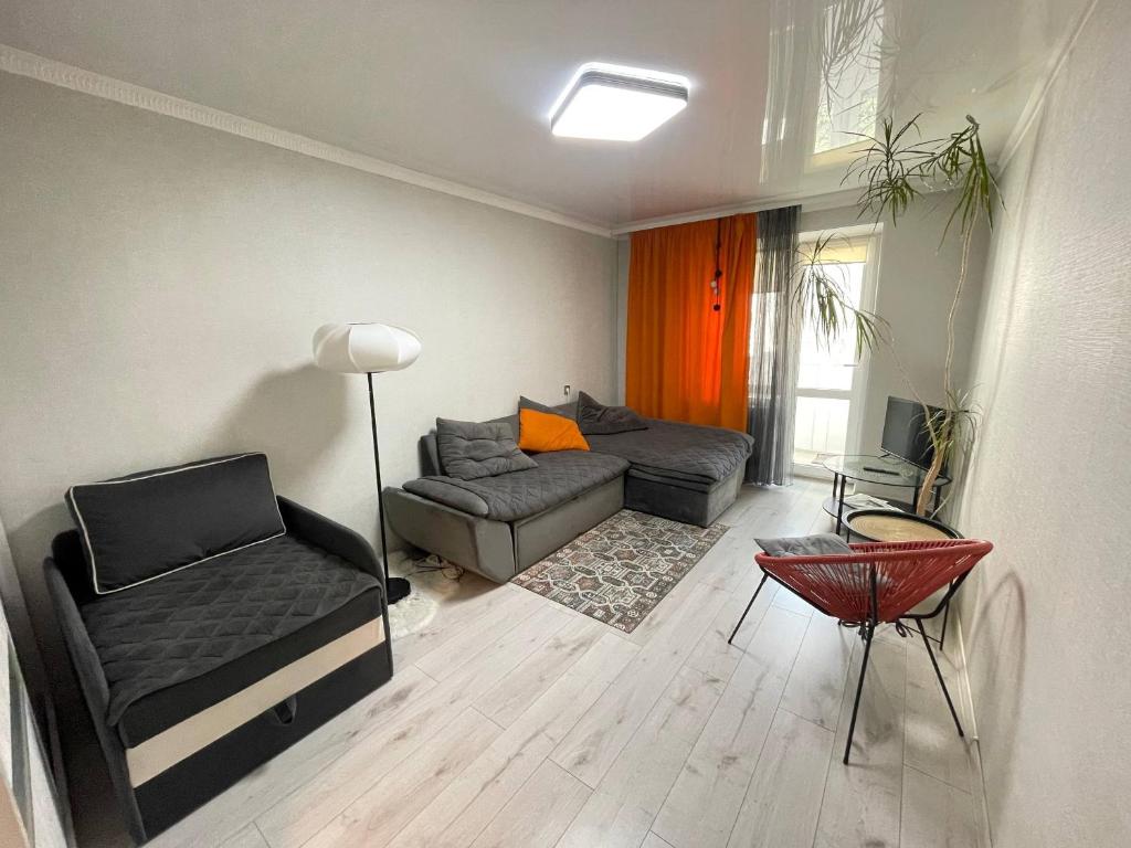a living room with a couch and a table at Comfort VV in Volodymyr-Volynskyi