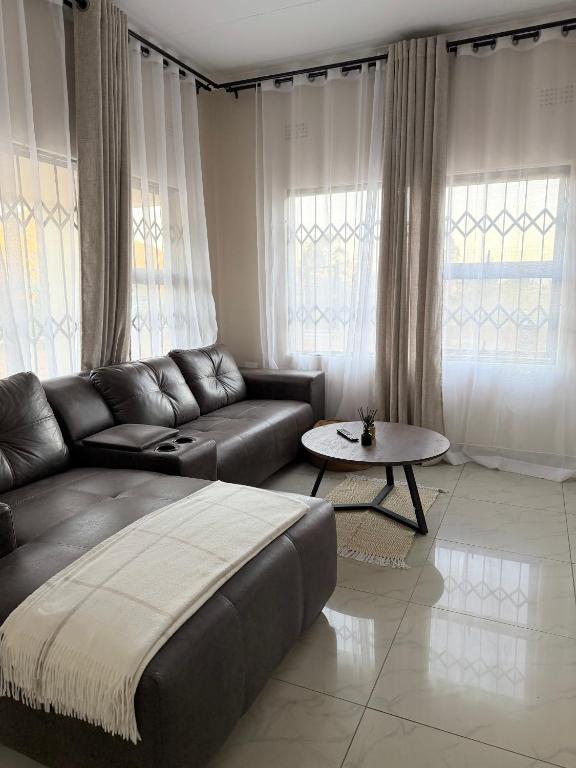 a living room with a couch and a table at Ekhaya Loft in Mbabane