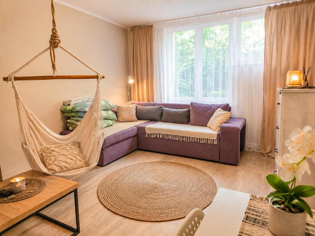 a living room with a couch and a hammock at Boho Quiet Studio Kraków in Krakow