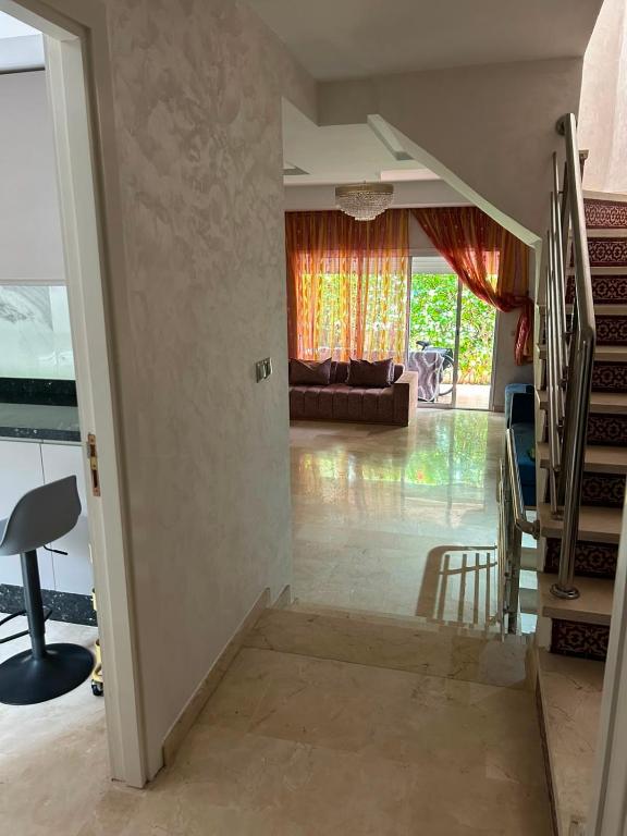 a living room with a staircase and a couch at Atlantic Beach View Villa in El Jadida