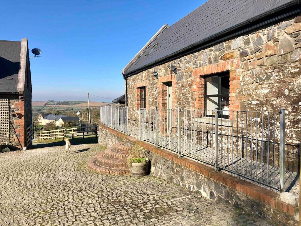 a brick building with a balcony on the side of it at Countryside Cottage in Ardee