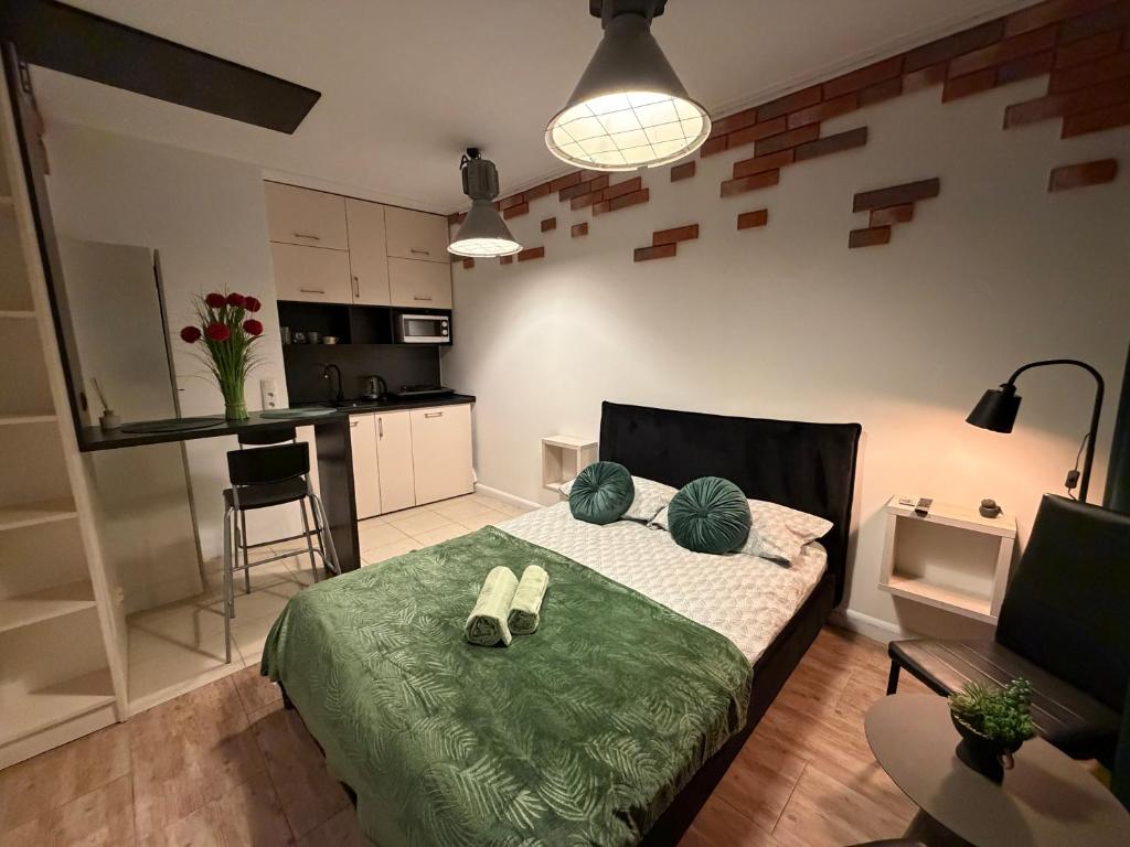 a bedroom with a bed with shoes on it at Cicha Przystań w Centrum -Mała Sienkiewicza in Kielce