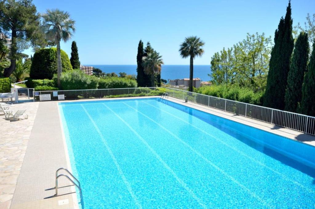 a swimming pool with a view of the ocean at Cannes Croix Des Gardes in Cannes