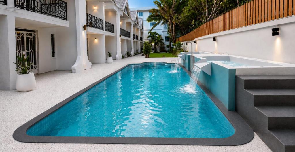 a swimming pool in the middle of a building at Elysee Vacances in Trou aux Biches