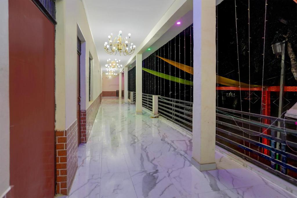 a hallway with purple marble floors and a chandelier at SPOT ON Hotel MS Grand in Lucknow