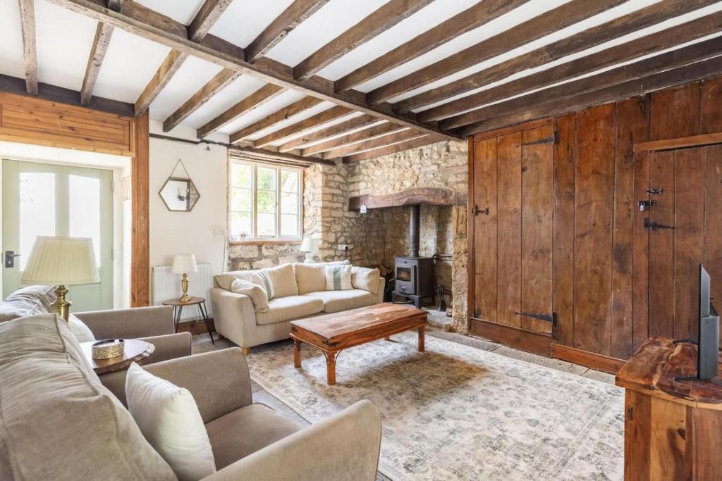 a living room with a couch and a table at Beamed Cottage in Broadwindsor, Wood Burner in Broadwindsor
