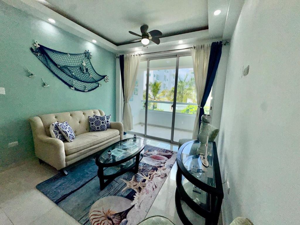 a living room with a couch and a window at Tepuy Residential in Juan Dolio
