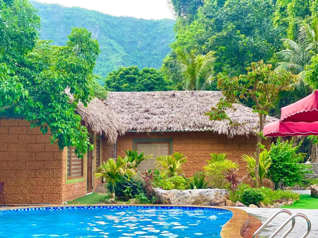 a resort with a swimming pool in front of a house at Mây Retreat in Nguyên Ngoại