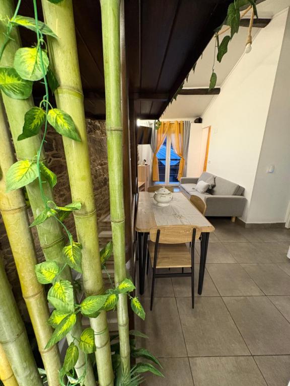 a living room with a table and bamboo poles at El renacer de Flor - Casa turística in Chandreja
