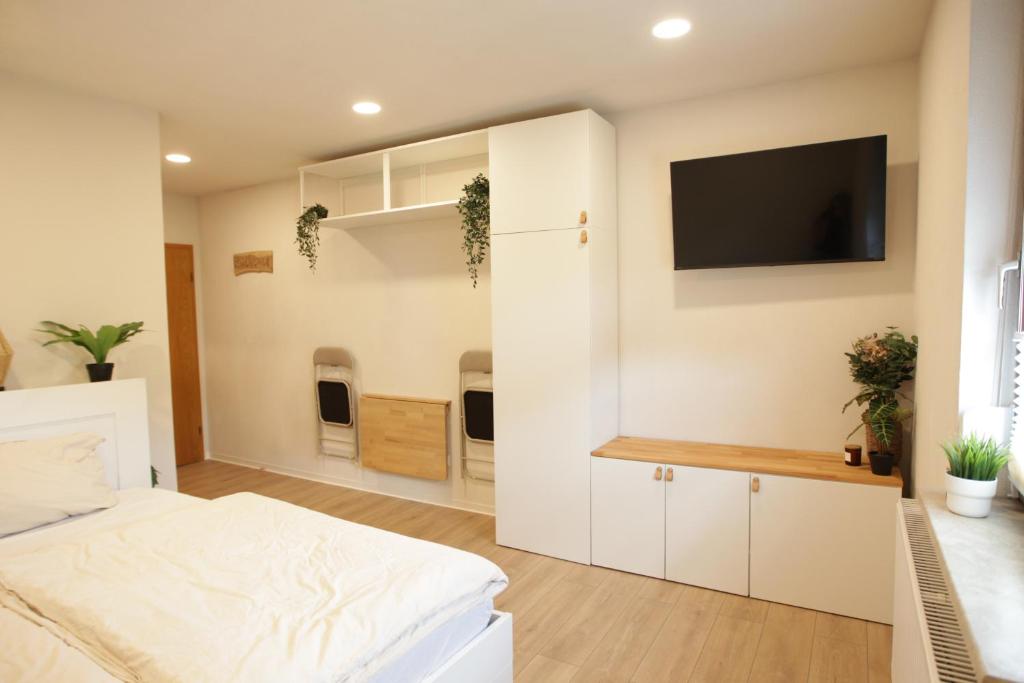 ein Schlafzimmer mit einem Bett und einem Fernseher an der Wand in der Unterkunft Ritterschlaf in Balingen