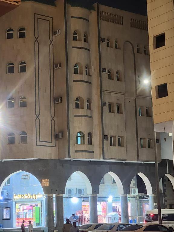 a large building with arches in front of it at Rahat Alubur Hotel in Medina