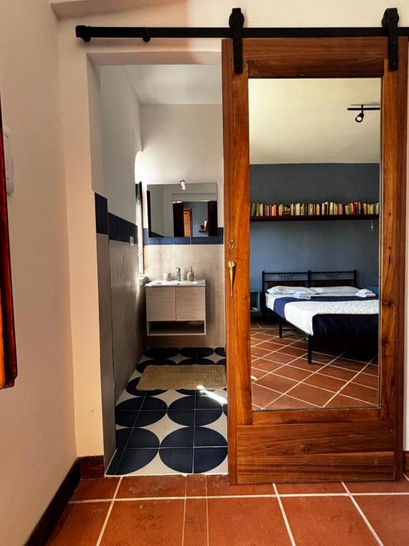 a bedroom with a bed and a door with a sink at Ara Solis in Arola