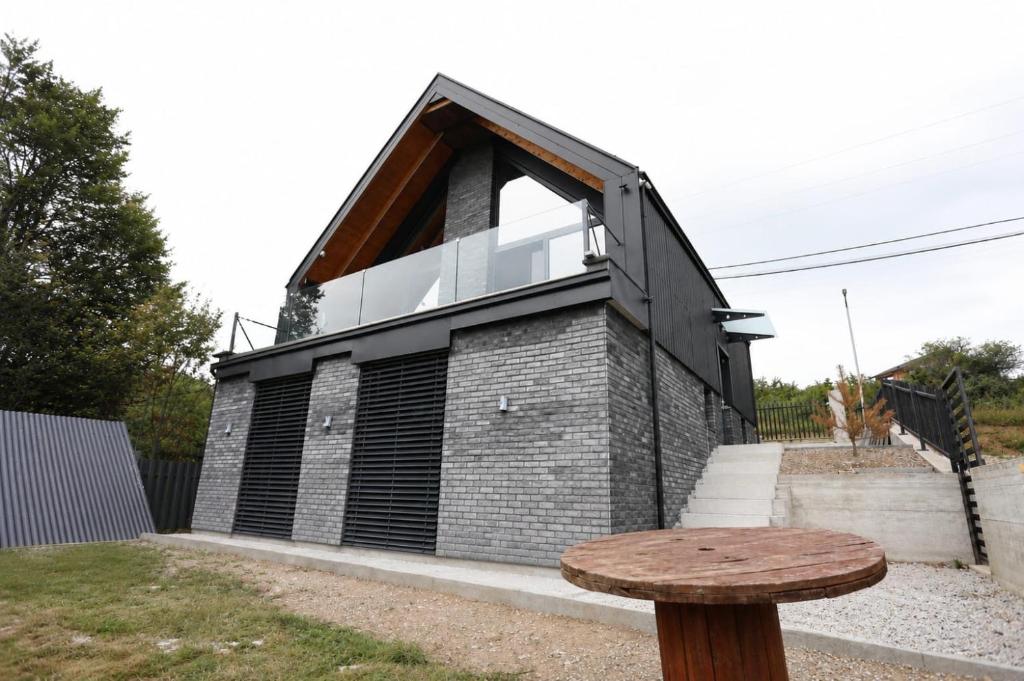 a small brick house with a window on the side at Black Villa in Prizren