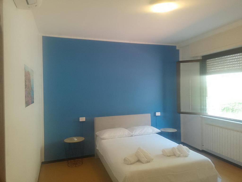 a bedroom with a blue wall and a bed at La casa di RÒ in Avegno