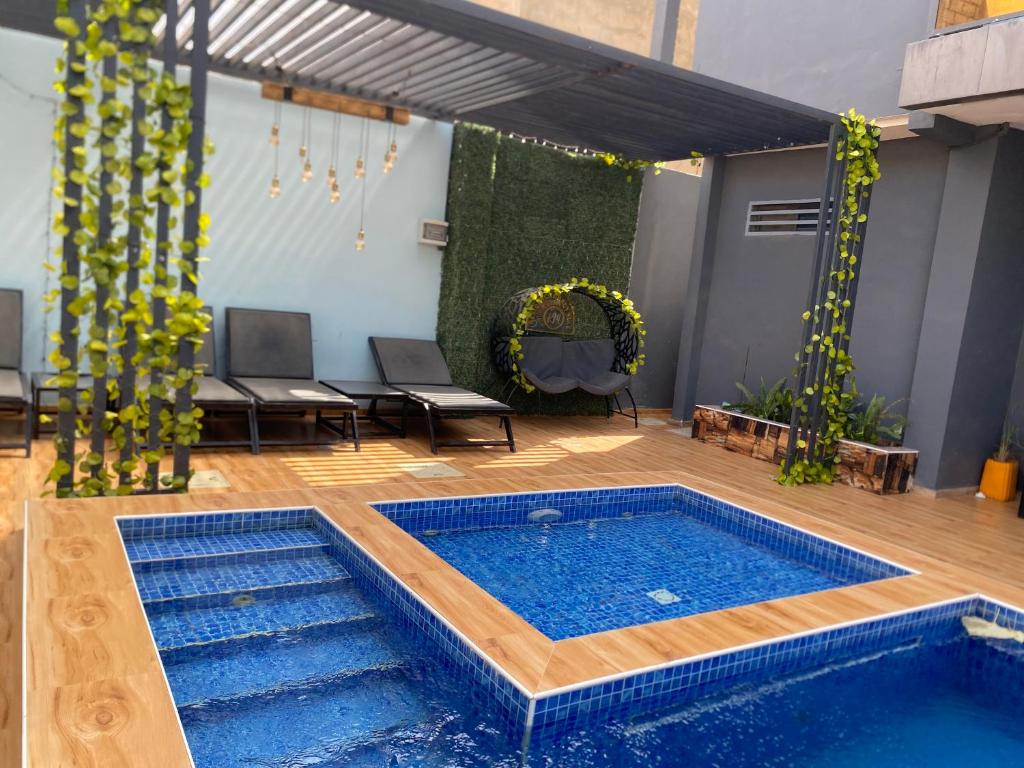 a pool in the middle of a patio with a table and chairs at Chamber double in Saly Portudal