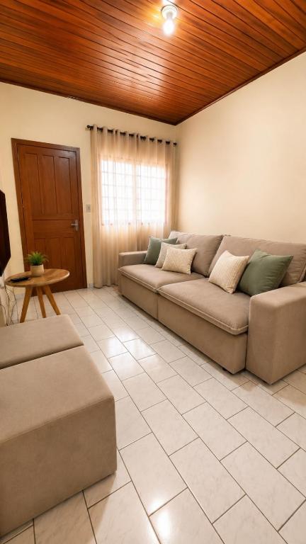a living room with a couch and a table at Casa no Centro Vilhena in Vilhena