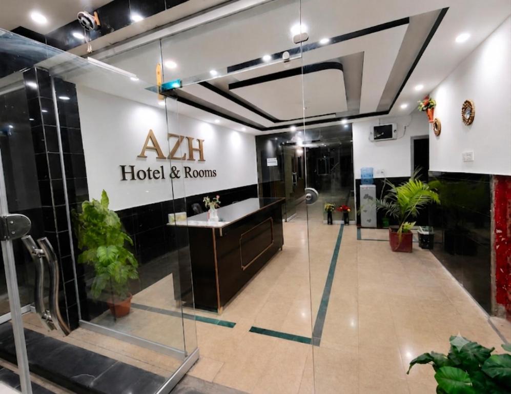 a lobby of aaa hotel and rooms with plants at AZH Hotel & Rooms in Islamabad
