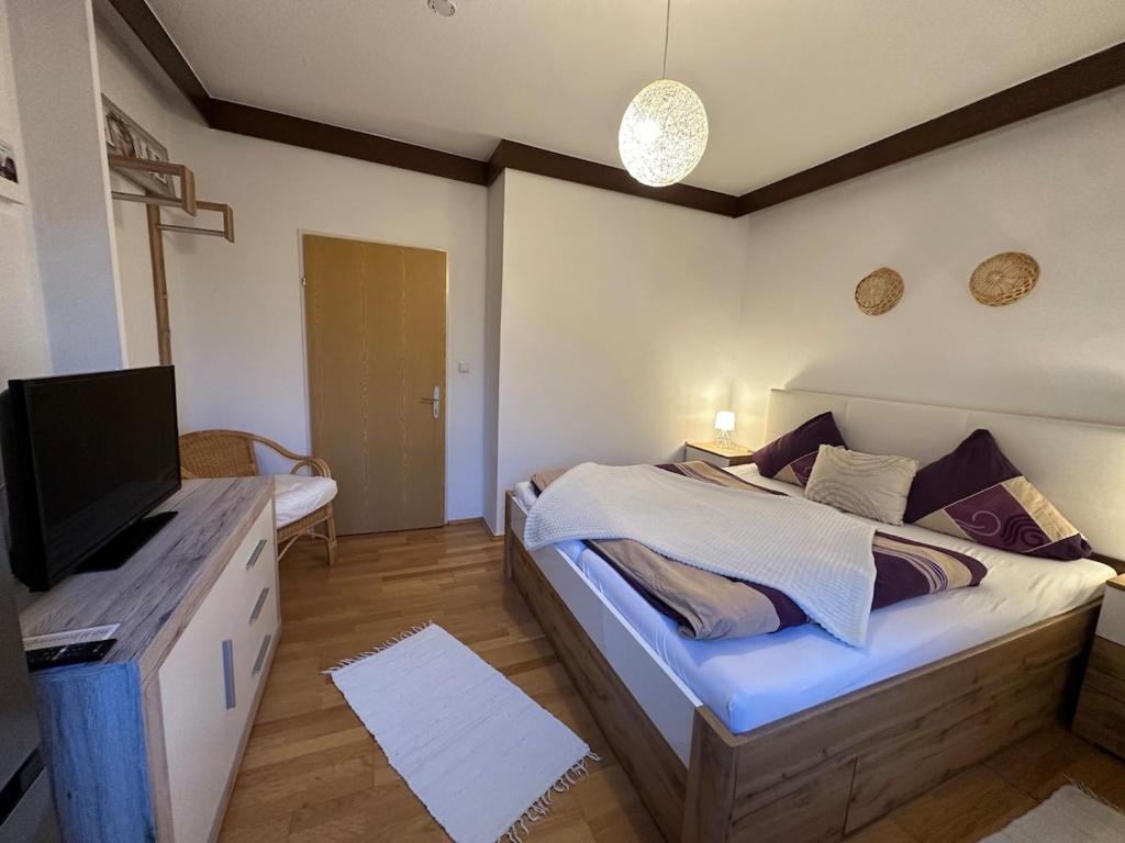 a bedroom with a bed with a flat screen tv at Max and Moritz Top 7 in Liebenau
