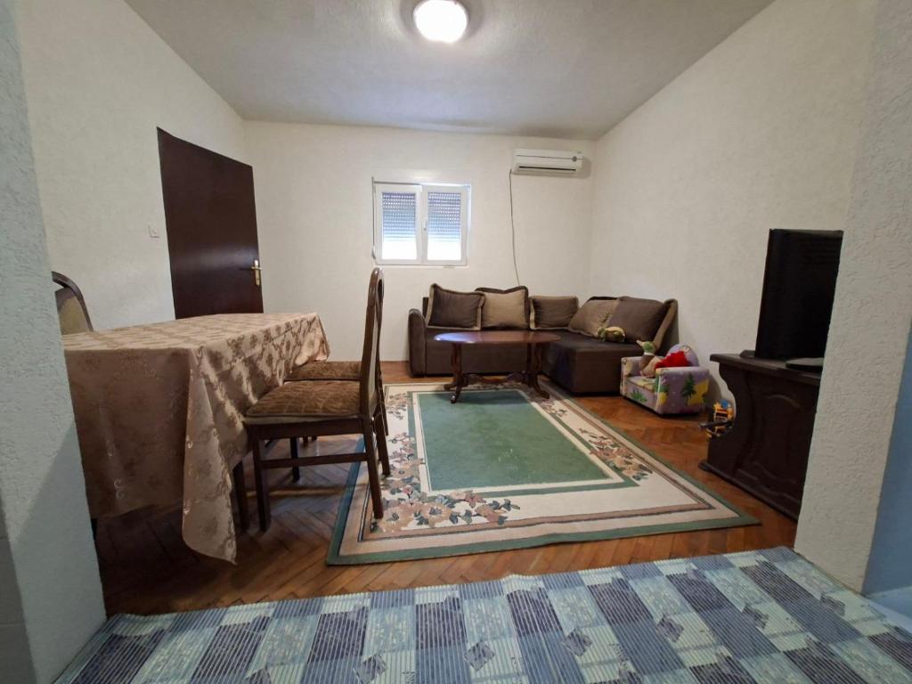 a living room with a table and a couch at Mareza in Podgorica