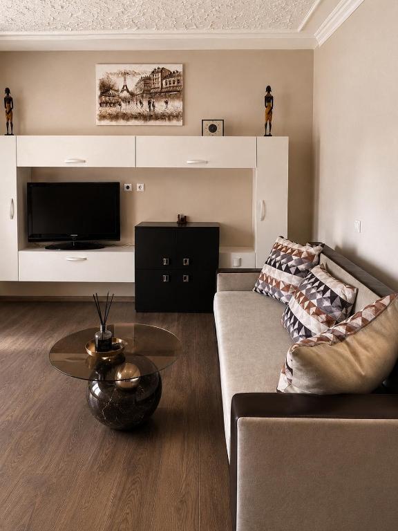 a living room with a couch and a table at Central apartments Pleven in Pleven