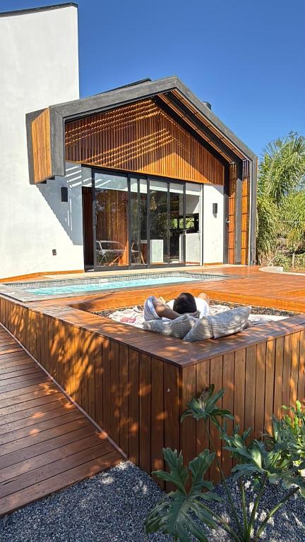 a person laying on a deck on a house at Cabana Komodo Bonito in Bonito
