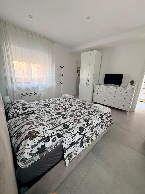 a bedroom with a bed and a dresser and a television at Corte del Gallo in Legnano