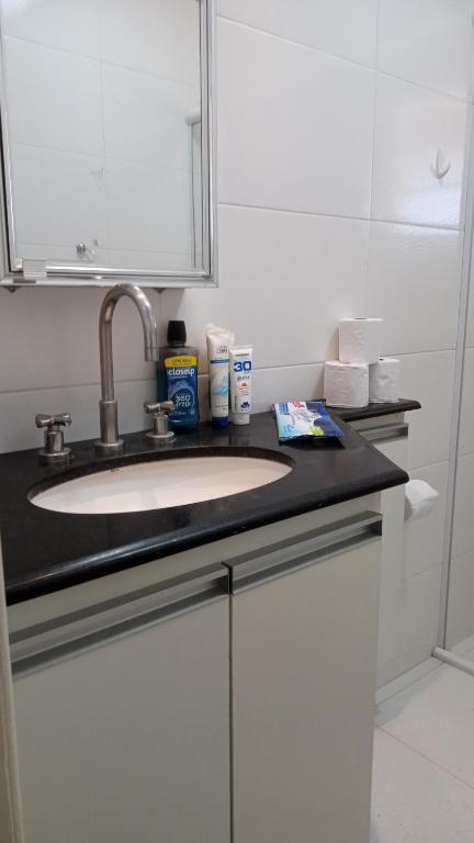 a bathroom counter with a sink and a mirror at Life Pinhalzinho in Pinhalzinho