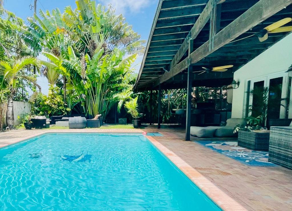 a swimming pool in front of a house at Dreampoolhousemiami in Miami