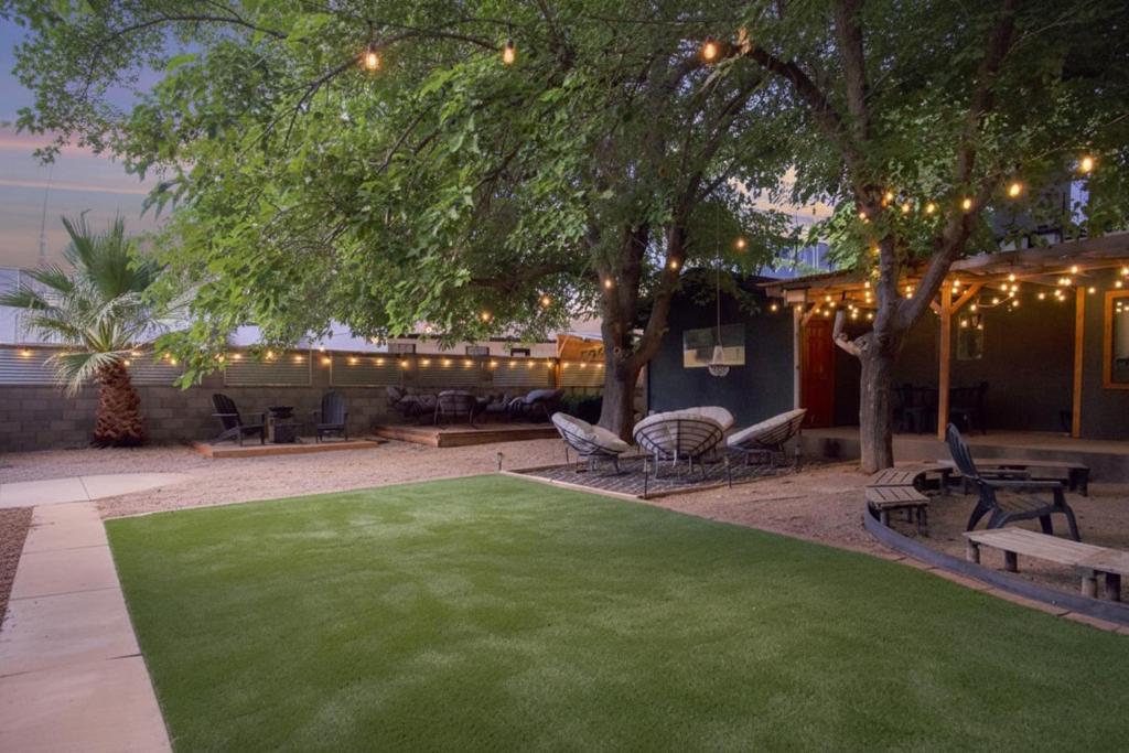 a yard with a green lawn and chairs and lights at Zion Base 3BR Home Backyard Oasis Pets Welcome in St. George