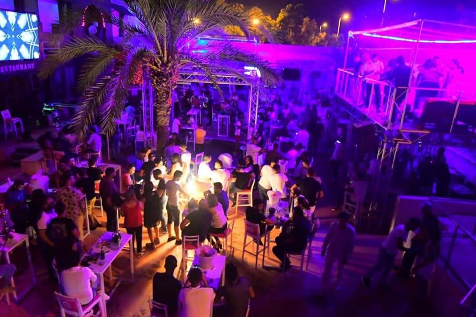 a crowd of people at a party at night at Disco tour Open Air Djerba in Djerba