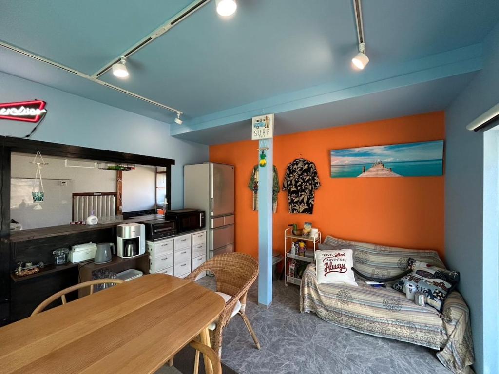 a living room with a table and a couch at Sea Retreat Nika in Kawazu