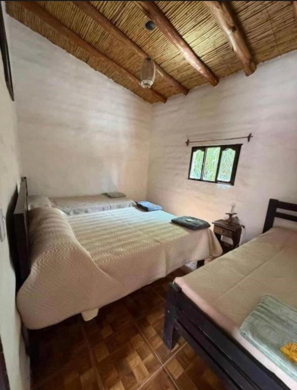a bedroom with two beds in a room at Cabañas el cardon in Maimará