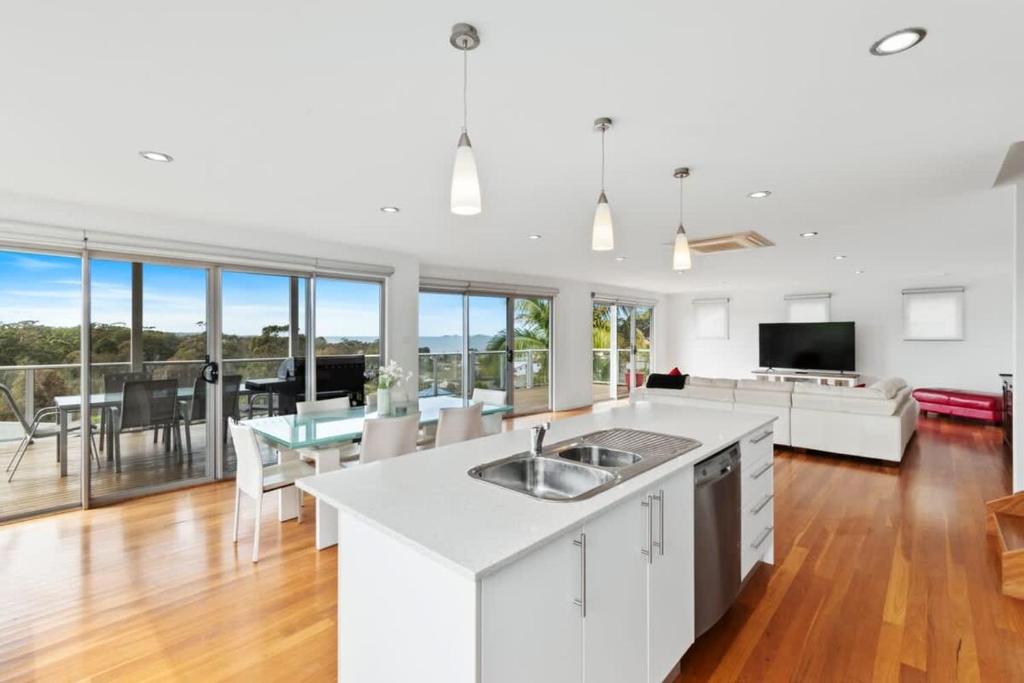 a kitchen and living room with a table and a couch at Three Sisters at Long Beach in Long Beach