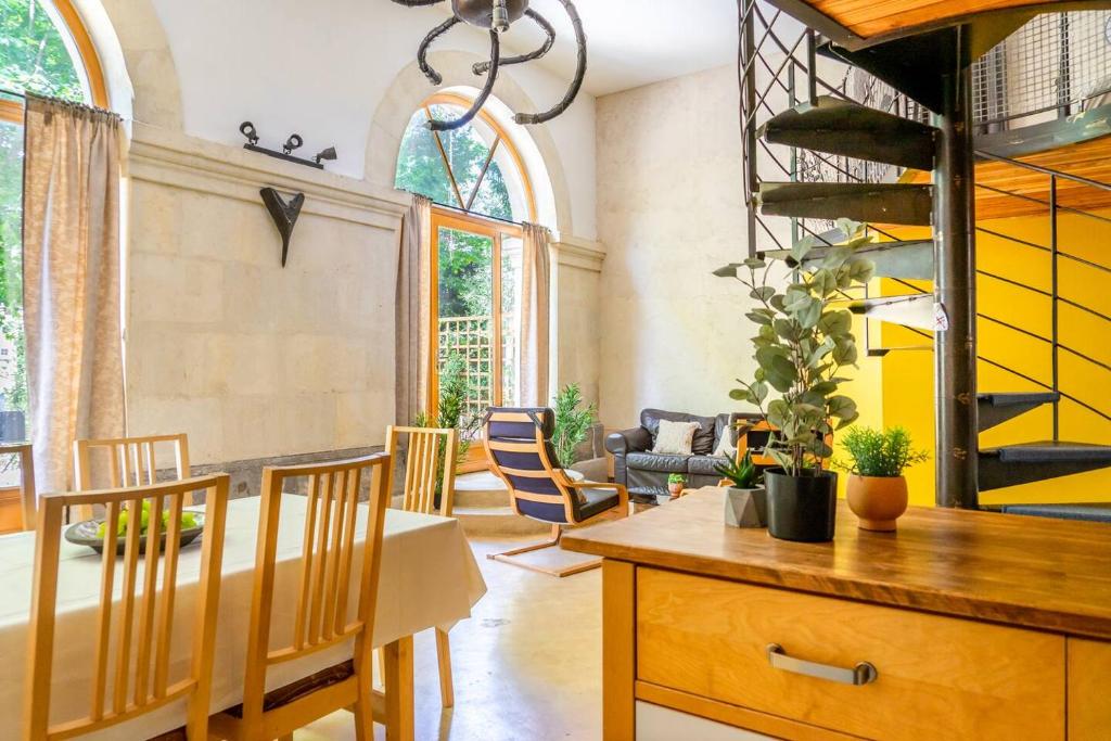 a dining room with a table and chairs at 5 Family Apartments with Pool & Large Garden in Historic Pézenas Convent in Pézenas