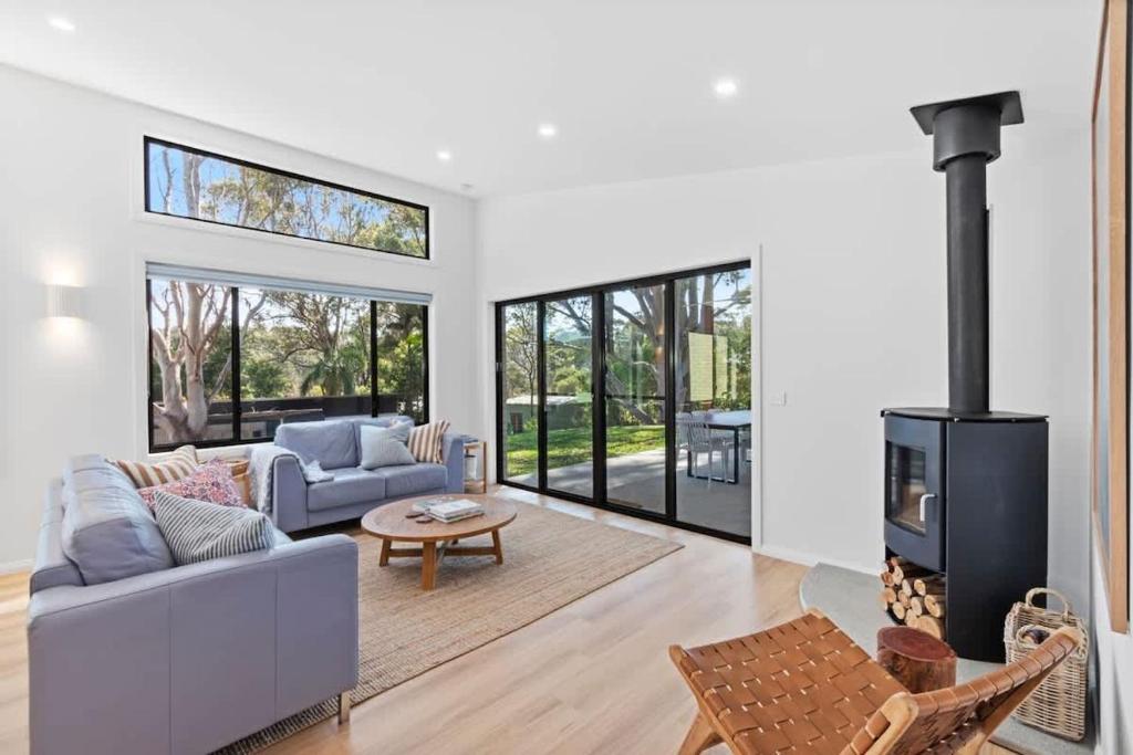 a living room with a couch and a fireplace at Tranquil at Rosedale in Tomakin