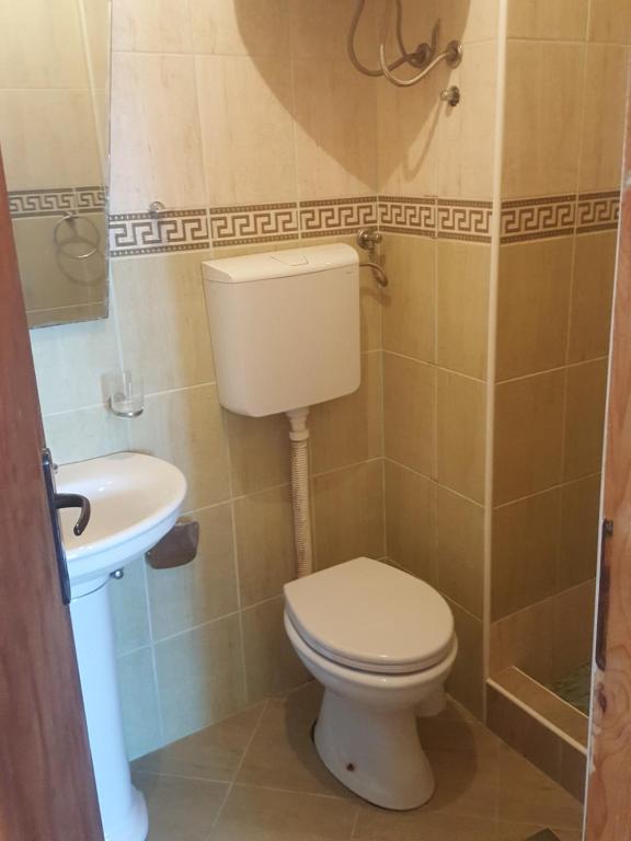 a bathroom with a toilet and a sink at Buljarica Bay Apartments in Petrovac na Moru