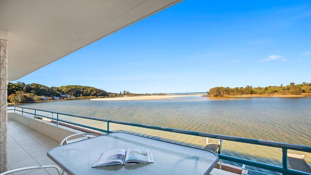 a table on a balcony with a view of the water at Quayside in Nambucca Heads
