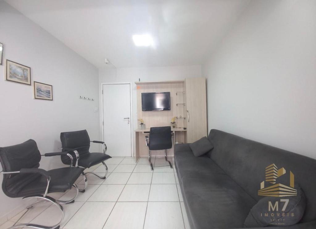 a living room with a couch and chairs at Loft Ponta Aguda in Blumenau