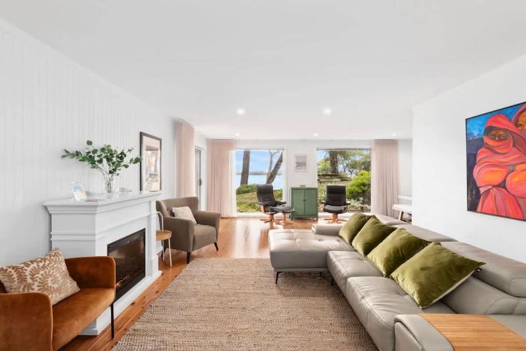 a living room with a couch and a fireplace at Long Beach Hideaway in Long Beach