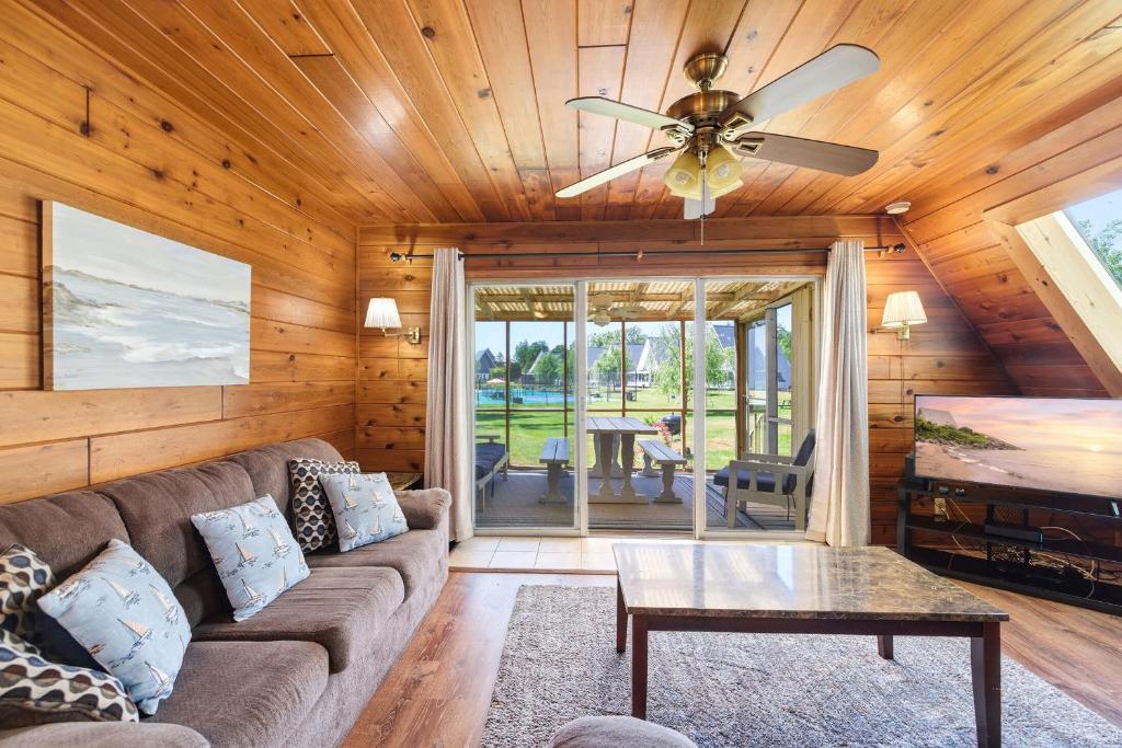 a living room with a couch and a ceiling fan at Chalet 71 in Stevensville