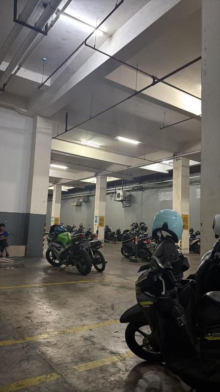 a group of motorcycles parked in a parking garage at apart iconmall SL in Singopadu