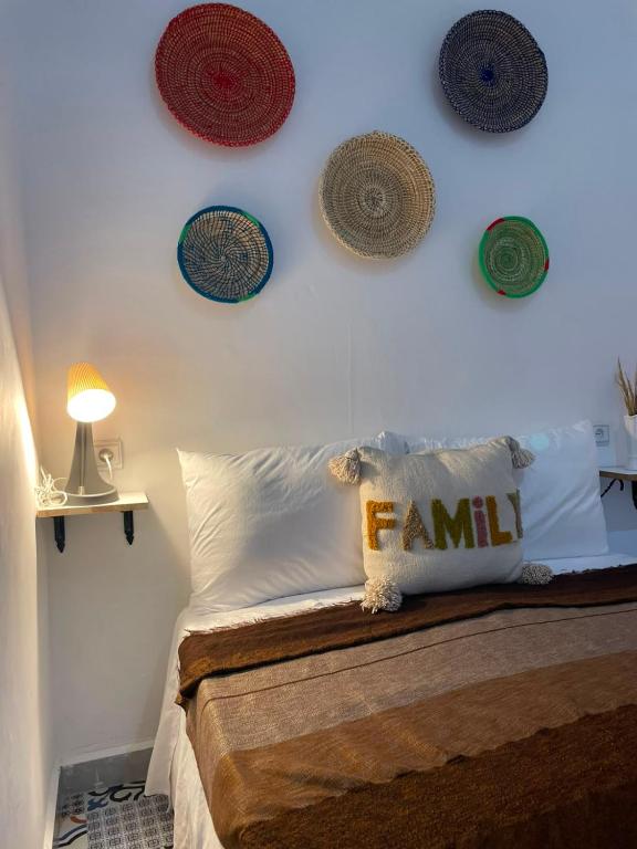 a bedroom with a bed with plates on the wall at Riad hotel borj in Tétouan