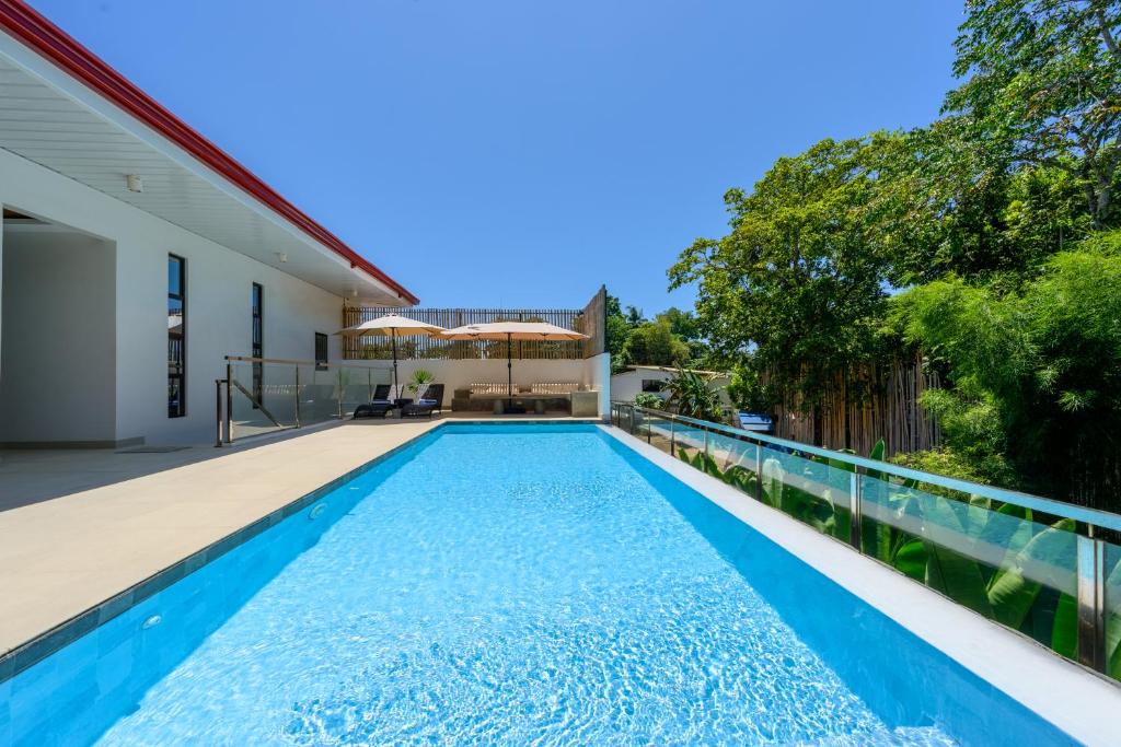 an infinity pool in the backyard of a house at Go Boutique Inn in Puerto Princesa City