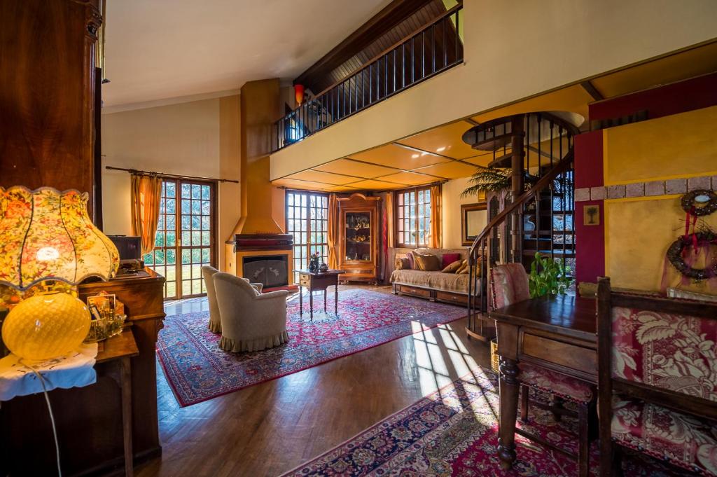 a living room with a staircase and a fireplace at B&B Al Roncaccio in Calco