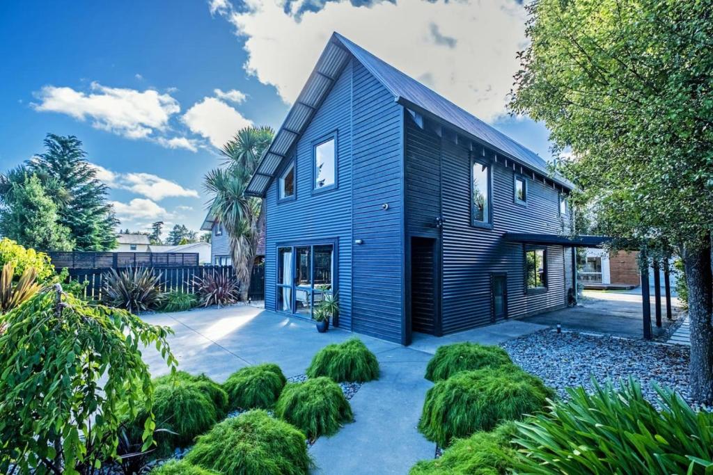 a house with a blue siding at Little Black Ski Chalet | Central, WiFi, Families! in Methven