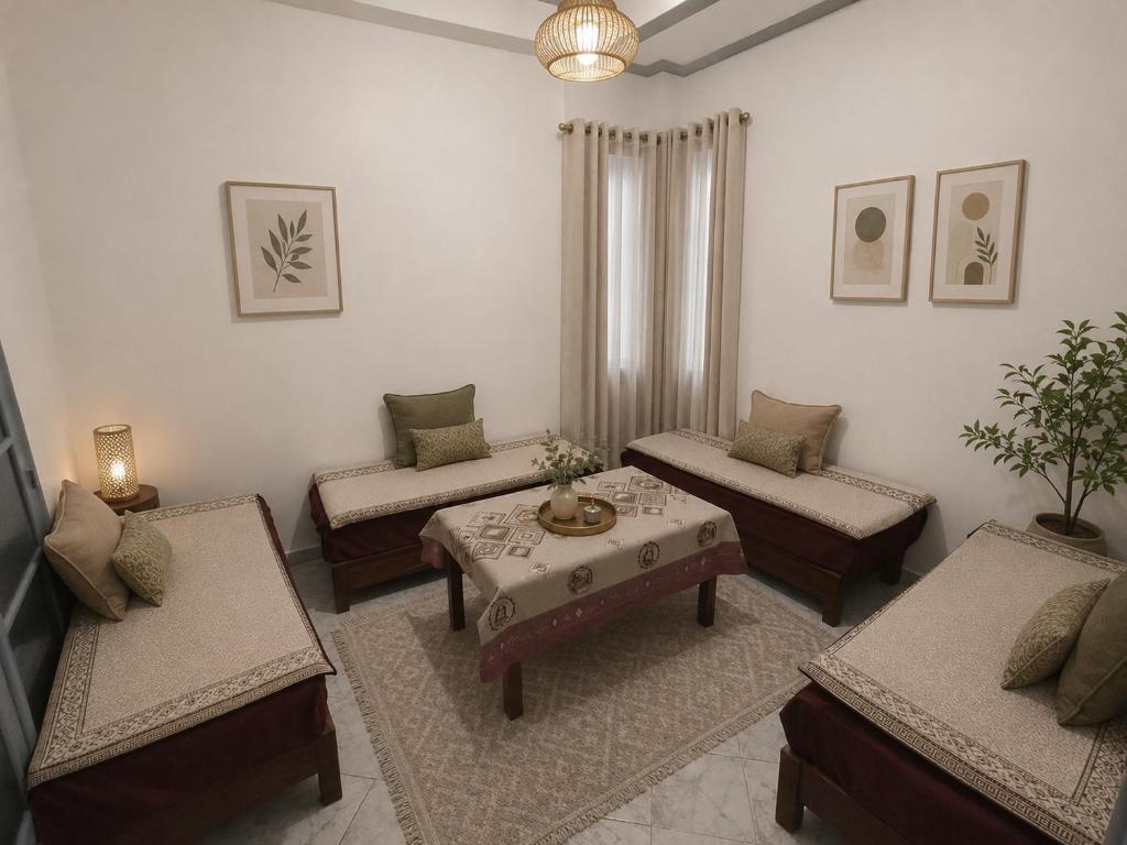 a living room with three couches and a table at مفروشة السعادة in Tlemcen