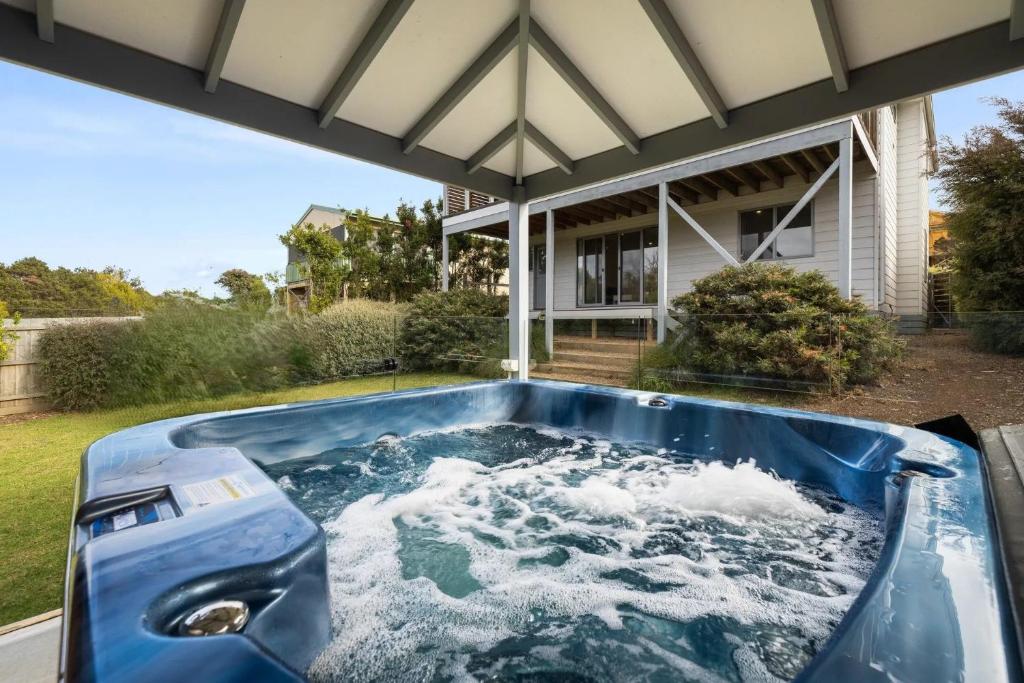 a hot tub in the backyard of a house at Sandy Toes Retreat in Smiths Beach