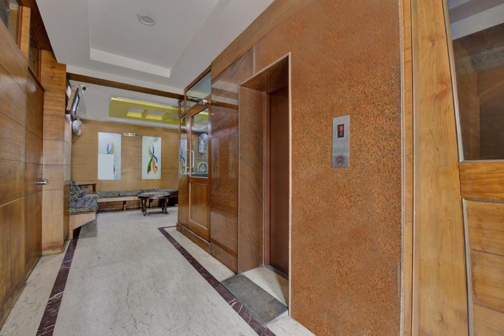 a hallway in a building with wooden walls at Capital O Jayam Residency in Chennai